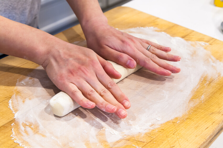 Rolling flour dough log